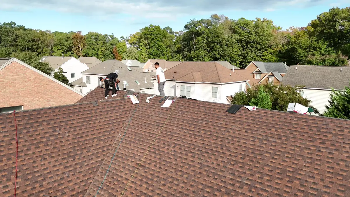 Drone view of the RoofTrue crew tearing off old shingles on a two-story home