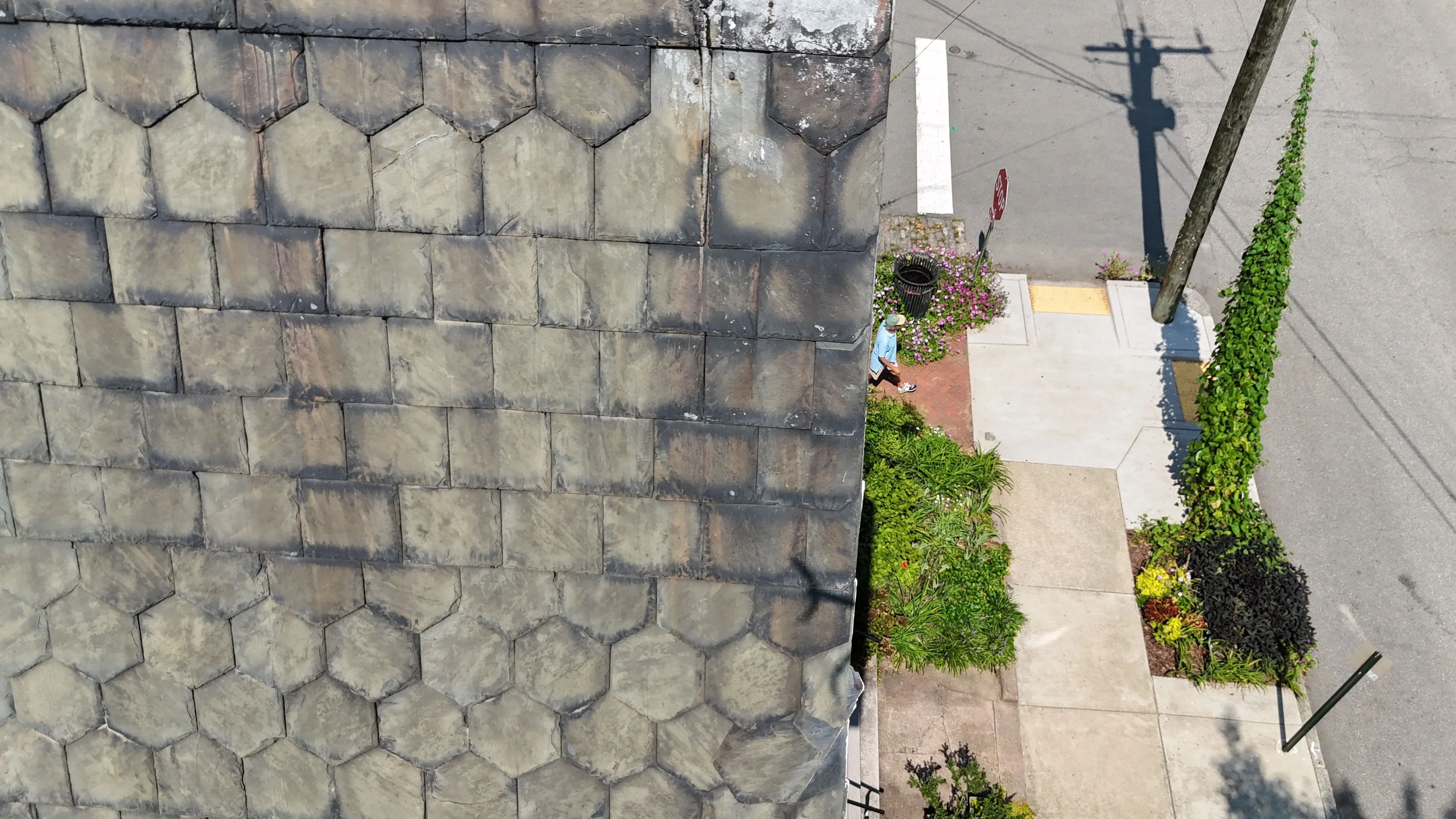 Aerial view of installed gray asphalt shingle roof with proper overlap and alignment